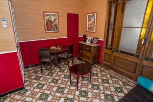 a room with a desk and a table and chairs at La Petite Calanque in Marseille