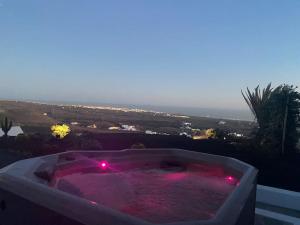 a hot tub with red lights in at private loft-sea views-Jacuzzi in La Asomada