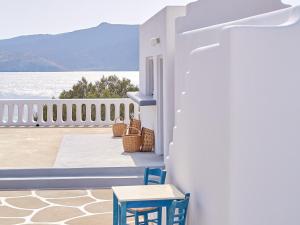 a balcony with chairs and a view of the water at Mykonos Lolita, A Grecotel Resort to Live in Agios Sostis Mykonos