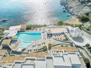 an aerial view of a resort with a pool and the ocean at Mykonos Lolita, A Grecotel Resort to Live in Agios Sostis Mykonos