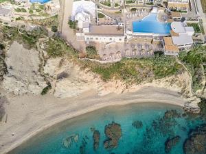 an aerial view of a mansion on a beach at Mykonos Lolita, A Grecotel Resort to Live in Agios Sostis Mykonos