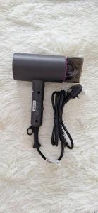 a blow dryer sitting on a blanket with a cord at Bunny Homestay 408 @ Roxy Apartment Kuching in Kuching
