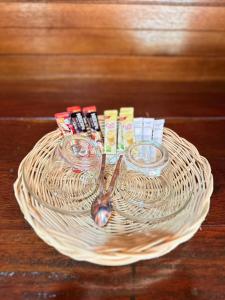 a wicker basket with two glasses and a spoon at บ้านสวนปิยนันท์ (Baansuan Piyanan) in Ko Yao Noi