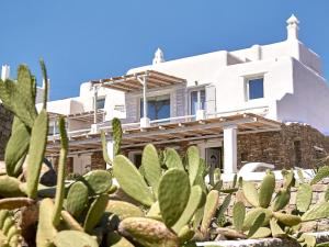 a house with a cactus in front of it at Mykonos Lolita, A Grecotel Resort to Live in Agios Sostis Mykonos