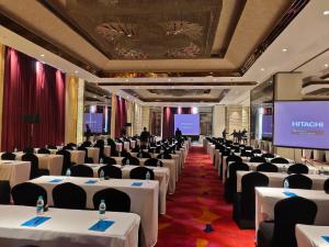 a conference room with white tables and chairs at Blue Bell Hotel - Greater Noida in Greater Noida