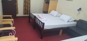 a bedroom with a bed with a phone on it at Cool Martin Family Hotel and Resort in Bacoor