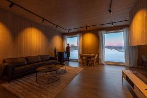 a living room with a couch and a table at Aurora Borealis Observatory in Silsand