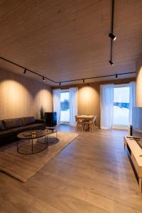 a living room with a couch and a table at Aurora Borealis Observatory in Silsand