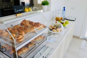 a display case with pastries and other food items at Verde Blu Vacanze B&B in Torre Lapillo