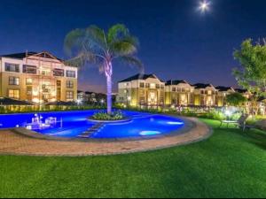 a home with a palm tree in the middle of a yard at URlyfstyle Kikuyu Escape Waterfall Mall of Africa in Midrand