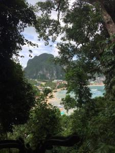 a view of the beach through the trees at Camp Talusi Hills Overlooking in El Nido