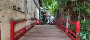 a red bridge over a street with people walking on it at Bukit Bintang Times Sq With 3 Bedroom 74 in Kuala Lumpur