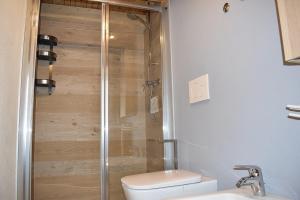 a bathroom with a shower and a toilet and a sink at Alla Valle in Gallio