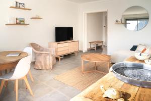 a living room with a couch and a table at ECHO DES FLOTS vue mer in Cassis