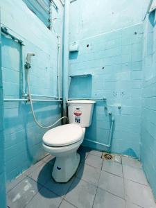 a blue bathroom with a toilet in a room at Lyna House in Hanoi