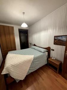 - une petite chambre avec un lit et une table de nuit dans l'établissement La maison de Linanna, à Aymavilles