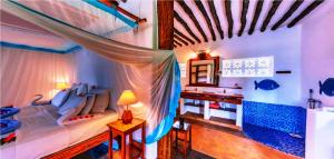 a bedroom with a bed and a desk in it at Fully Private 390sqm VILLA 3stars NO SHARING serviced Matemwe beach in Gazija