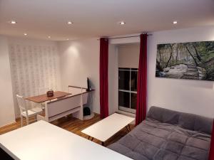 a living room with a desk and a couch at Rentcenter79_2 in Sankt Michael in Obersteiermark
