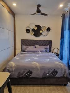 a bedroom with a large bed with a fan at HarbourBay Residence. Batam. Studio. 1min to Ferry in Jodoh