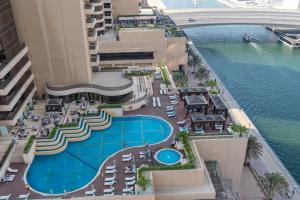 an overhead view of a resort with a swimming pool at Vacay Lettings -2 Bed Iris Blue Dubai Marina in Dubai
