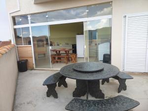 a patio with a table and two chairs and a table at Alto padrão !Forno Pizza! Hidro !Vista linda! in Poços de Caldas