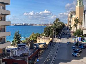 a street in a city with the ocean in the background at Casa Boccardi in Taranto