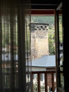 a view of a building from a window at Hotel Svanseti in Mestia