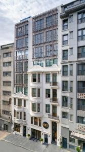 a tall white building with a lot of windows at Nex Hotel & Spa Istanbul in Istanbul