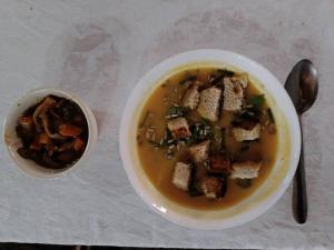a bowl of soup next to a bowl of food at Mia Safari Lodge and Restaurant in Entebbe