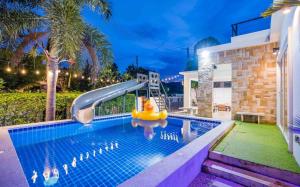 a swimming pool with a slide in a house at Space X Slider 4 Bedrooms Pool Villa Huahin in Hua Hin