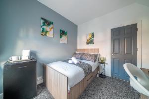 a small bedroom with a bed and a black door at *Rb12s* For your most relaxed & Cosy stay + Free Parking + Free Fast WiFi * in Headingley