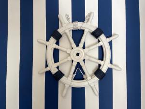 a blue and white striped wall with a steering wheel at Casa Morandi SPIAGGIA in San Vincenzo