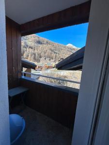 a bathroom with a window with a view of a mountain at appartement à la Foux d'Allos in La Foux