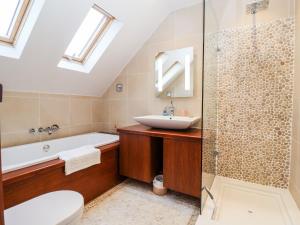 a bathroom with a sink and a tub and a toilet at Lampland House in Southwold +39 photos