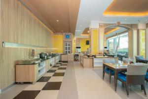 a large kitchen with a checkered floor at Sira Grande Hotel & Spa in Patong Beach