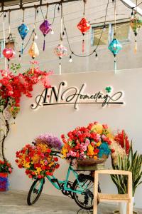 a bike is parked in a store with flowers at A.N Homestay in Phan Thiet