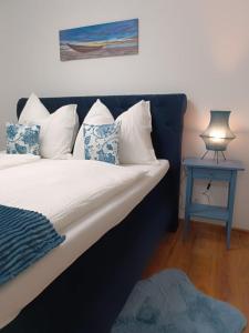 a bedroom with a bed with a blue end table at Cozy Stay Apartments in Salzburg