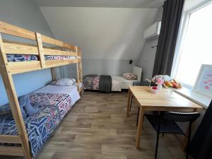 a room with two bunk beds and a table at Гостевой Отель-125 in Aktau