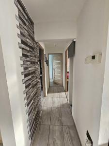 a hallway of a house with a brick wall at Modern Urban Haven: Stylish Getaway in Knockmore