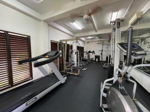 a gym with several treadmills and tread machines at Suite by the Sea Apartment Seminyak in Seminyak