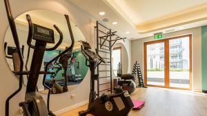 a gym with two treadmills and a mirror at VacationClub - Apartamenty Zakopiańskie Apartament 44 in Zakopane