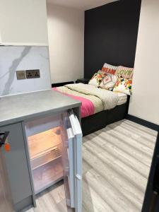 a small room with a bed and a table in it at Studio apartment in Catford