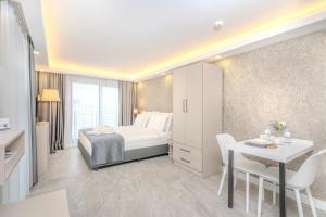 a bedroom with a bed and a table and chairs at Olea Suites Gemlik in Gemlik
