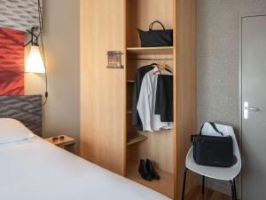 a room with a bed and a closet at ibis Cannes Plage La Bocca in Cannes