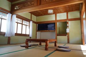 a room with a wooden table and some windows at TOSAYAMA BASE 清流沿いの里山　古民家貸切　高知市街地より車で約20分 in Kochi