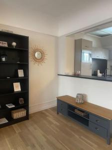 a living room with a table and a shelf at La Bretonnerie *T2* in Orléans