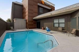 a swimming pool in front of a house at La Quinta by Wyndham Round Rock North in Round Rock