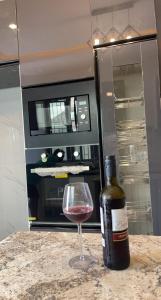 a bottle of wine sitting next to a glass of wine at Blueprint Apartment in Akure