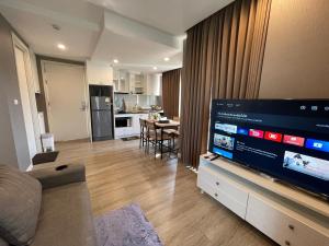 a living room with a large flat screen tv at The Blu X Family grand Suite in Ban Bang Saen (1)