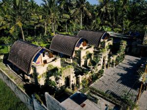 an aerial view of a building with trees in the background at Alvia Joglo House & Private Pool in Tampaksiring
